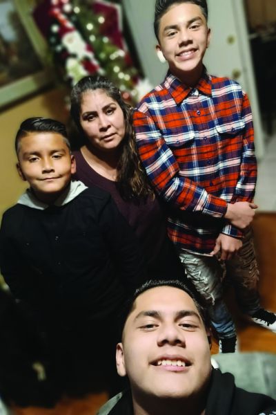 Family of three boys and mother during the holidays posed for camera