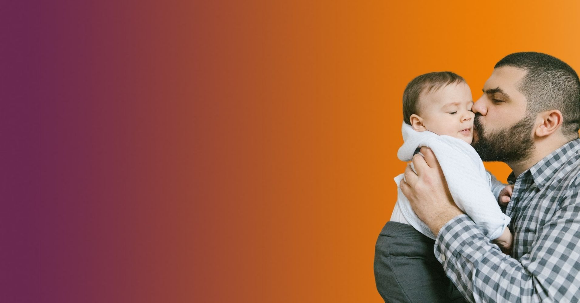 Dad kissing the cheek of his small child.