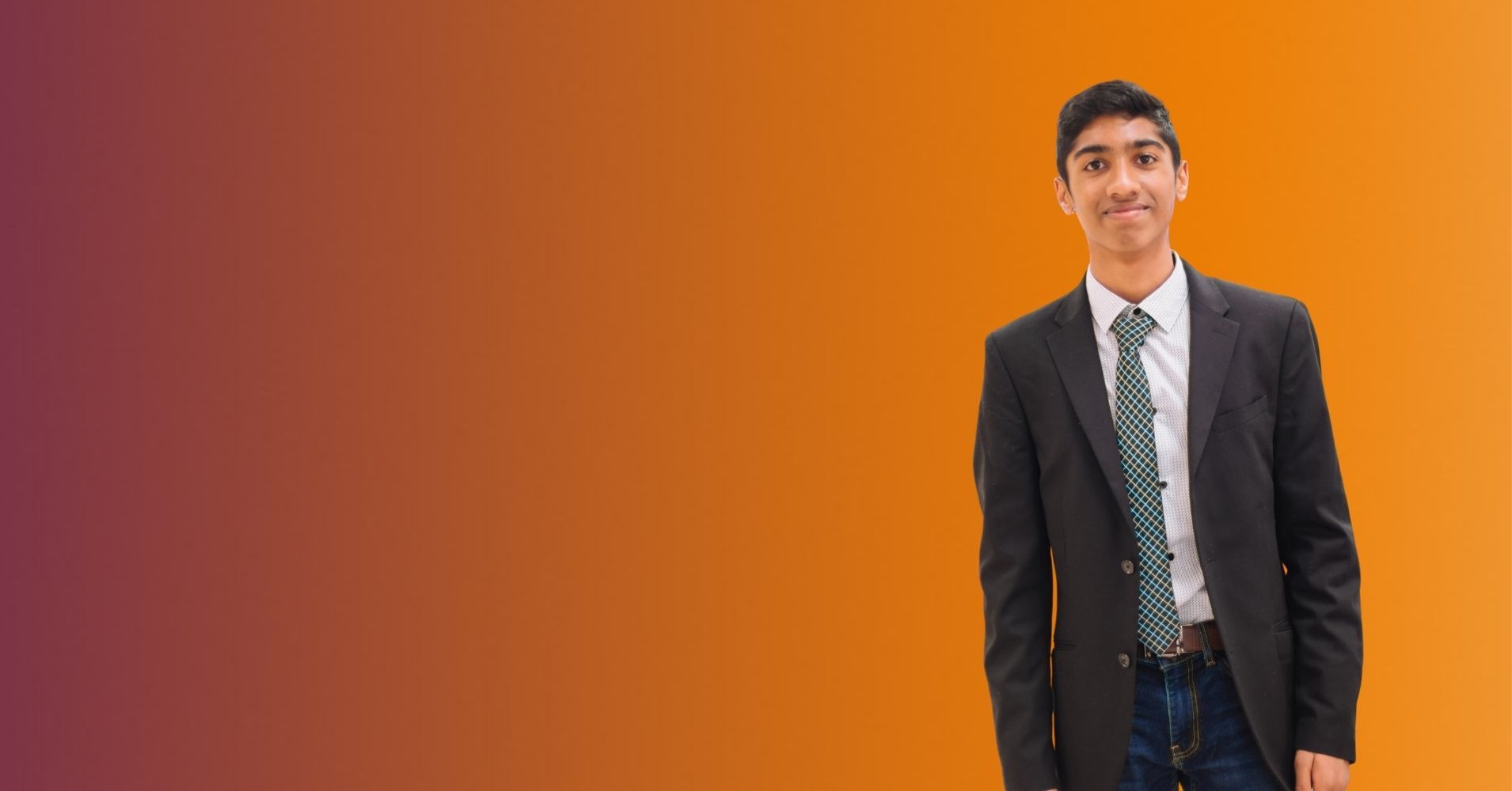Young man in sport jacket with tie and jeans.
