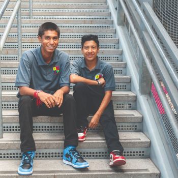 two young men on the steps in PLN uniforms