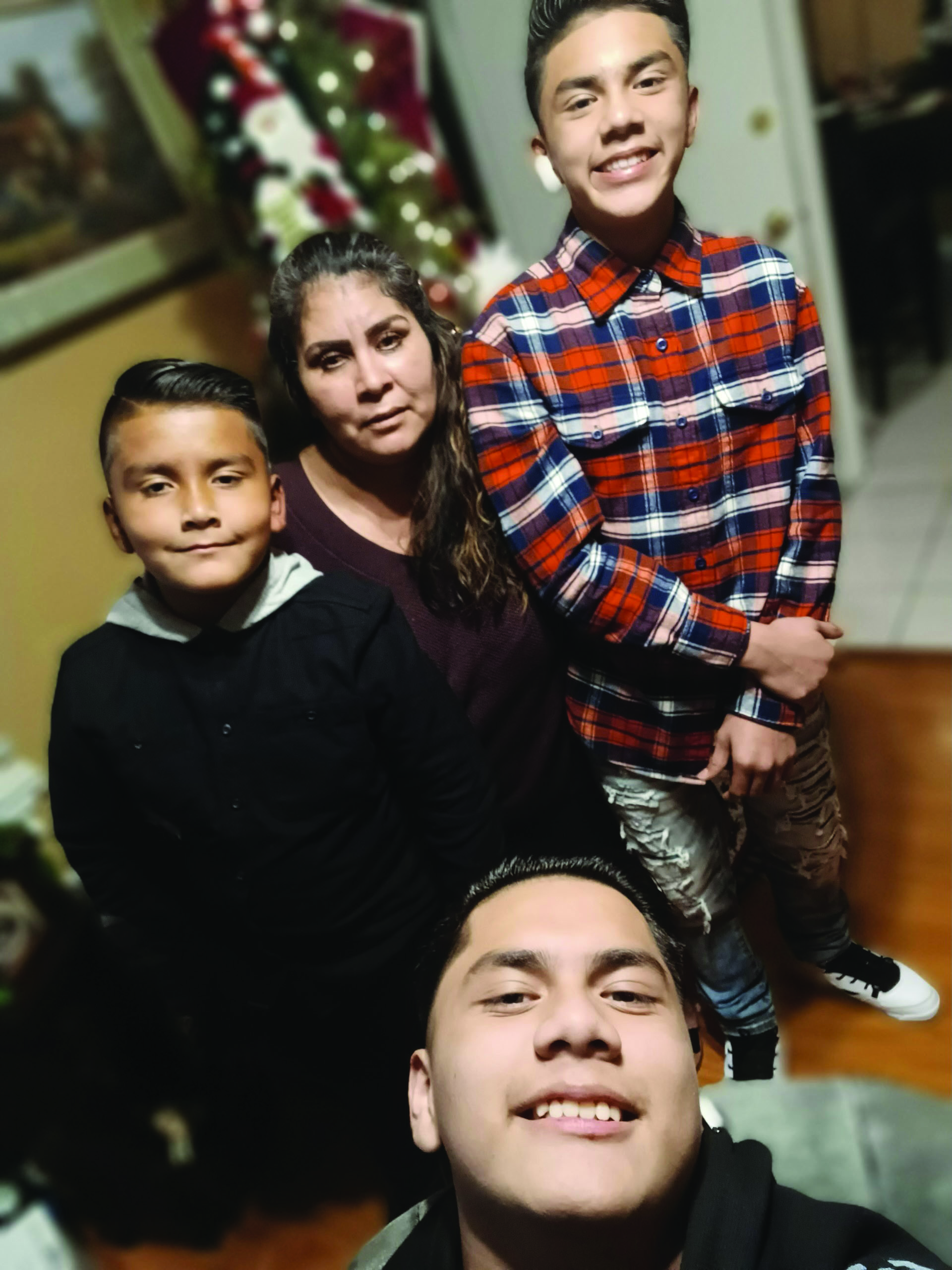 Family of three boys and mother during the holidays posed for camera